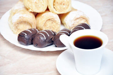 Puff pastry rolls with cream, chocolate and coffee potatoes