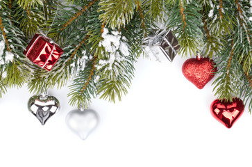 Fir tree branch with christmas decor covered with snow