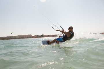 Kiteboarder enjoy surfing