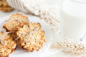 ruddy cookies with wheat flakes and glass of milk