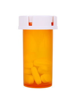 medical pill bottle with pills isolated on white background.