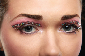 Obraz premium Woman eye with exotic style makeup