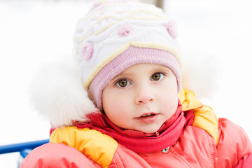 Beautiful happy kid in the red jacket