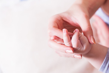 Baby hand in mother hand