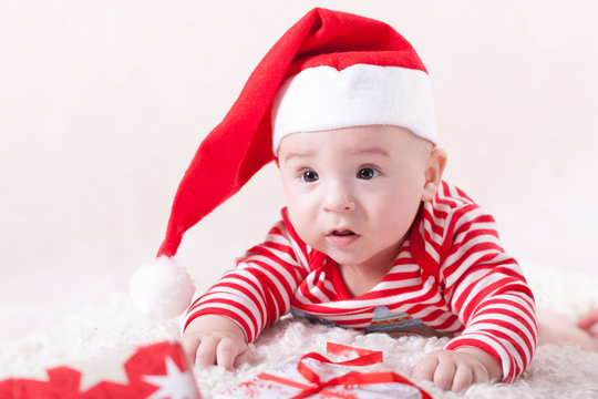 Little baby with santa's cap and presents