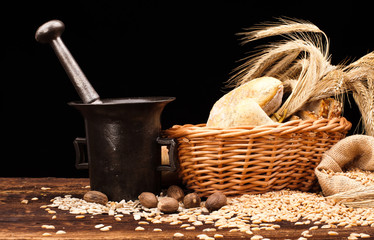 assortment of baked bread on wood table and black background