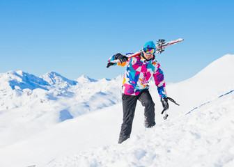 Young man with skis and a ski wear