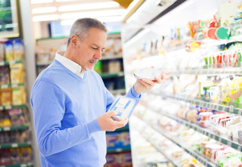 Customer comparing products in a supermarket