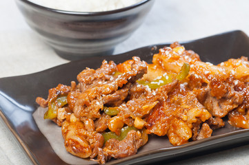 korean beef barbeque with rice cakes and rice on a side