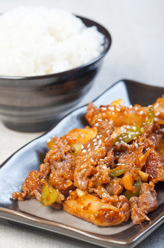 korean beef barbeque with rice cakes and rice on a side