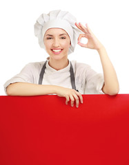 Chef woman holding a blank board and showing ok