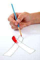 Hand painting an AIDS ribbon