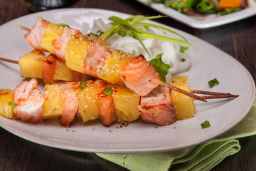 salmon skewers with pineapple, rice noodles and mango salad