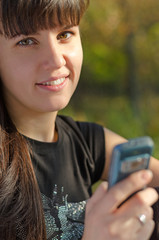 Smiling woman holding a mobile