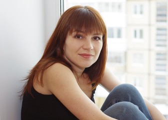 Portrait of woman at a window overlooking the next house