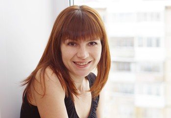 Portrait of woman at a window overlooking the next house