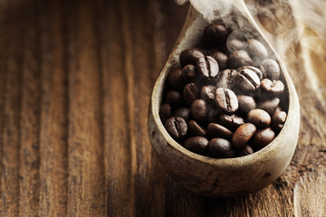 Fototapeta premium Close up of wooden spoon with coffee beans on it