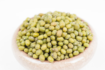 Green mung beans in bowl on white background