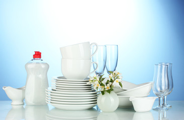 empty clean plates, glasses and cups with dishwashing liquid
