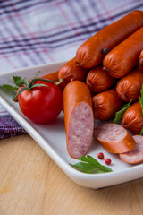 Sausages on plate with cherry tomato