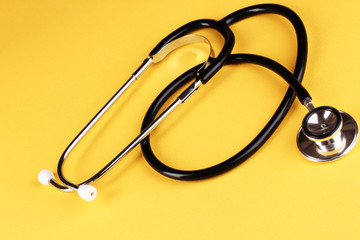 Stethoscope on orange background