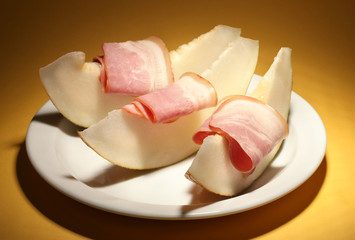 parma ham and melon, on yellow background