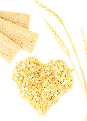Heart shape made from oat flakes with spikelets isolated