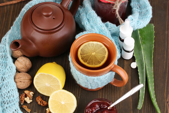 Helpful tea with jam for immunity on wooden table close-up