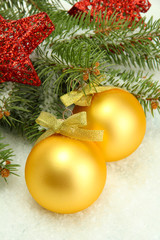Christmas balls on fir tree with snow, isolated on white