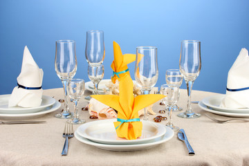 Table setting in white and yellow tones on color  background