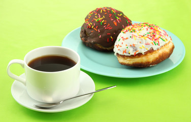 Tasty donuts on color plate on color background