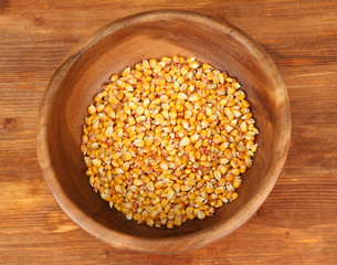 Corn in wooden bowl  on wooden background