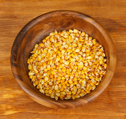 Corn in wooden bowl  on wooden background