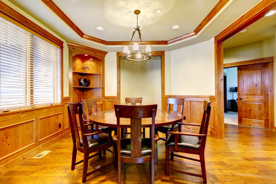 Dining luxury room with wood molding and floor.