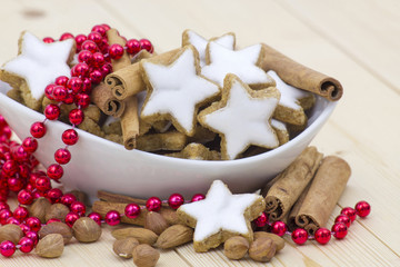 typical christmas cinnamon star cookies, nuts and cinnamon stick