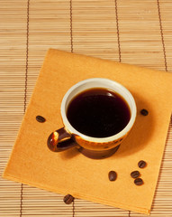One cup of coffee with coffee beans on the table