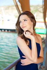 beautiful young brunette woman posing on covered dock