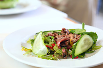 Salad with a meat on the plate