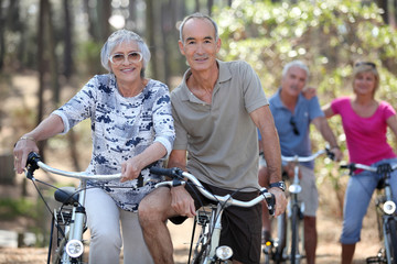 Mature couples on a double date biking.