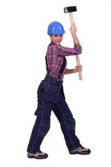 Woman wielding sledge-hammer