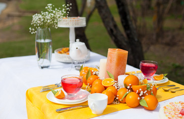 beautiful wedding table decoration with stylized orange