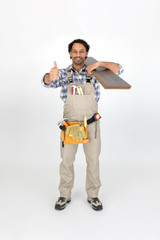 Man carrying laminate flooring on shoulder