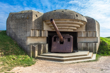 Gun emplacement at Omaha Beach in Normandy,France. - obrazy, fototapety, plakaty
