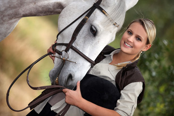 Young woman with her horse