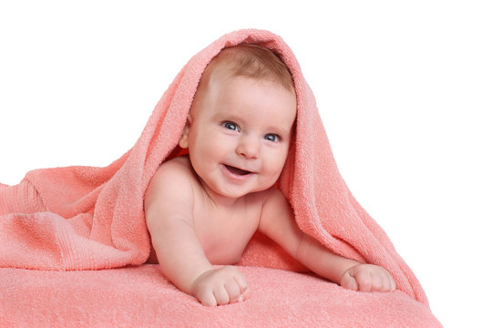 Happy smiling baby in pink towel