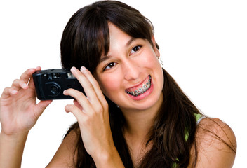 Smiling teenage girl photographing