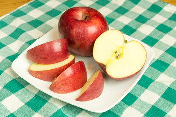 Winesap apple slices on white plate
