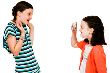 Smiling girl taking picture of girl