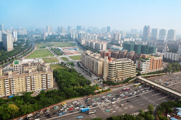 Modern skyscrapers and many cars on highway in Guangzhou, China.