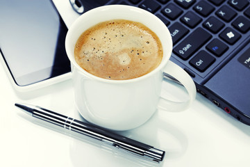 A cup of coffee and laptop